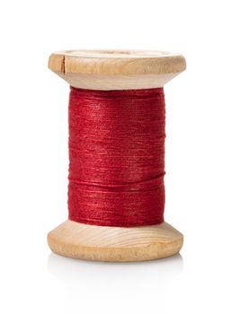 spool of red thread on white isolated background
