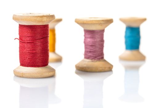 coils with colorful thread on white isolated background