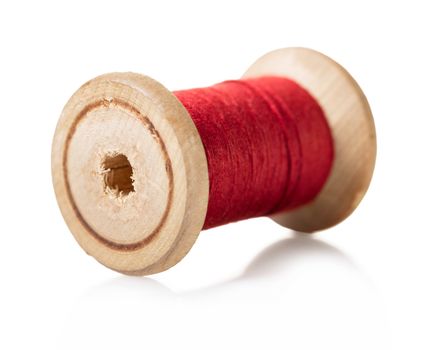 spool of red thread on white isolated background