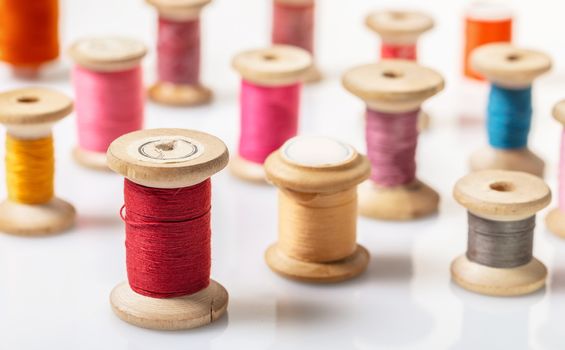 coils with colorful thread on white background