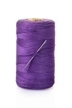 spool of purple threads on a white isolated background