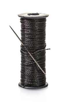 spool of black thread on white isolated background