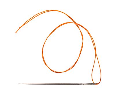 orange thread in a needle on a white isolated background