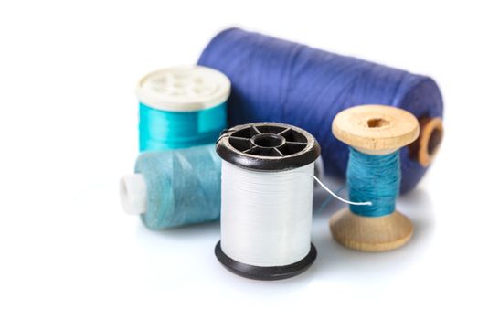 coils with colorful thread on white background