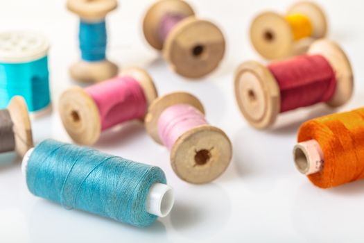 coils with colorful thread on white background