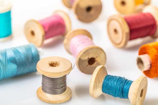 coils with colorful thread on white background