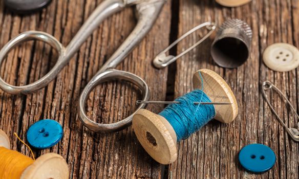 thread and sewing accessories on a wooden background