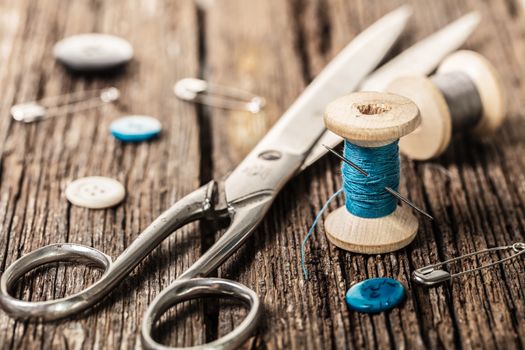 thread and sewing accessories on a wooden background