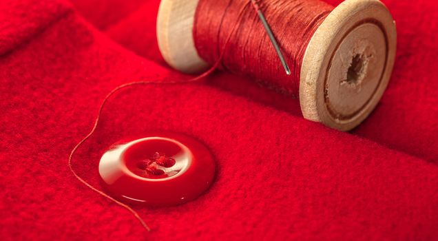 red thread with buttons on the background of lining fabric