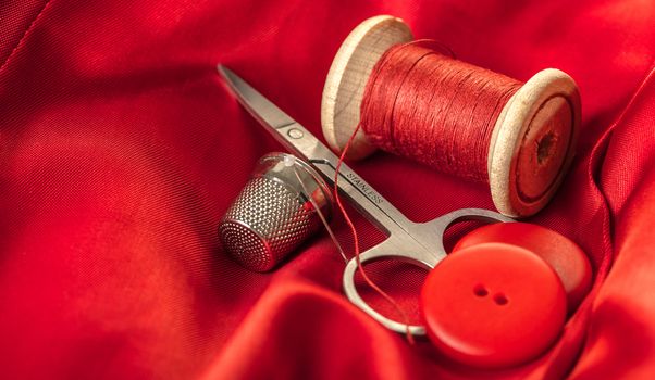 red thread with buttons on the background of lining fabric