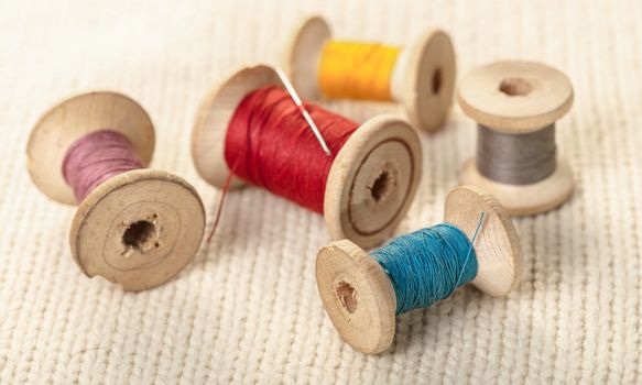 coils of colored thread on white knitted fabric