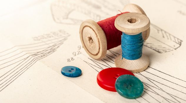 coils of colored threads on a background of paper pattern