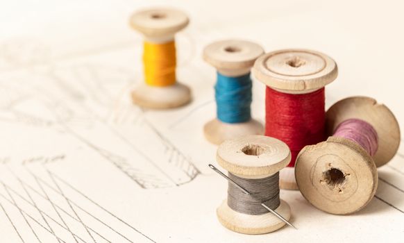 coils of colored threads on a background of paper pattern