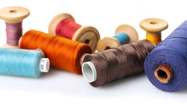 coils with colorful thread on white background