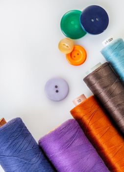 coils with colorful thread on white background