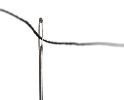 black thread in a needle on a white isolated background