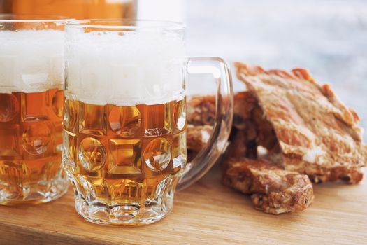 Barbecue pork ribs with beer. On wooden background.