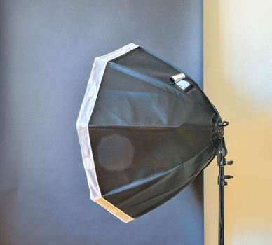 Empty photo studio with lighting equipment. Black background in photo studio.