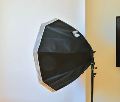 Empty photo studio with lighting equipment. White background in photo studio.