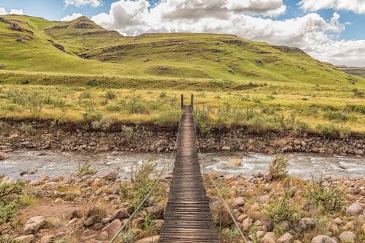 Pedestrian bridge over the Mlambonja River at the start of the Three Pools hiking trail at Garden Castle in the Drakensberg