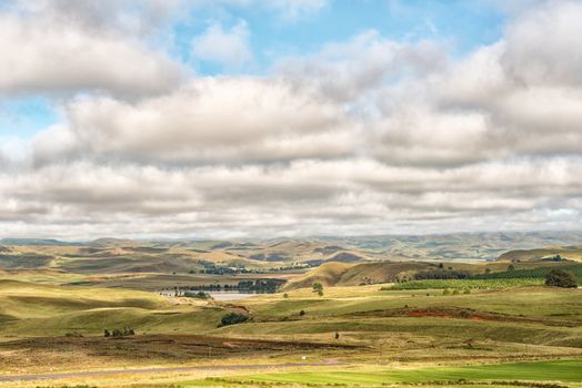 A farm landscape on the R617-road between Underberg and Kokstad in the Kwazulu-Natal Province. Lake Curragh is visible