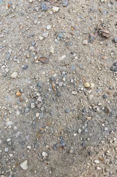 Texture of dry soil ground with stones close-up