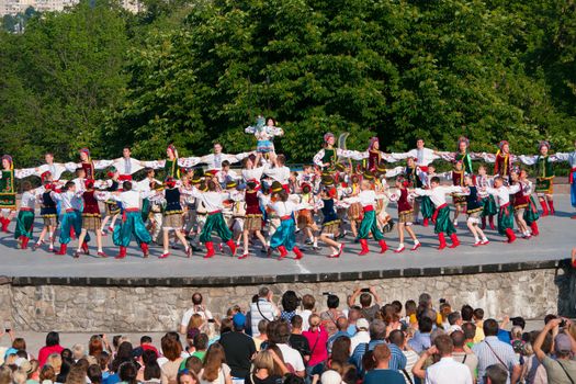 KIEV, UKRAINE - July 22 , 2016: Ukraina School of Dance Ensemble girls and boys dressed in traditional red Ukrainian embroidered costume clothes dancing