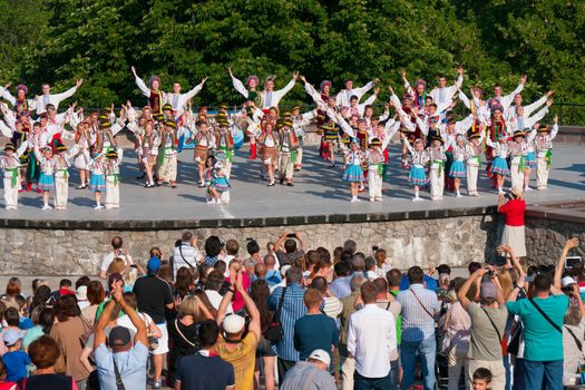 KIEV, UKRAINE - July 22 , 2016: Ukraina School of Dance Ensemble girls and boys dressed in traditional red Ukrainian embroidered costume clothes dancing