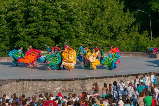 KIEV, UKRAINE - July 22 , 2016: Ukraina School of Dance Ensemble girls and boys dressed in traditional red Ukrainian embroidered costume clothes dancing