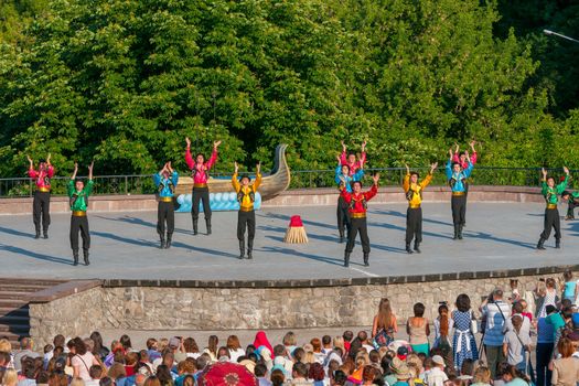 KIEV, UKRAINE - July 22 , 2016: Ukraina School of Dance Ensemble girls and boys dressed in traditional red Ukrainian embroidered costume clothes dancing