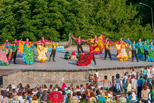 KIEV, UKRAINE - July 22 , 2016: Ukraina School of Dance Ensemble girls and boys dressed in traditional red Ukrainian embroidered costume clothes dancing