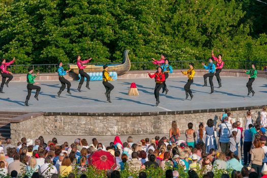 KIEV, UKRAINE - July 22 , 2016: Ukraina School of Dance Ensemble girls and boys dressed in traditional red Ukrainian embroidered costume clothes dancing