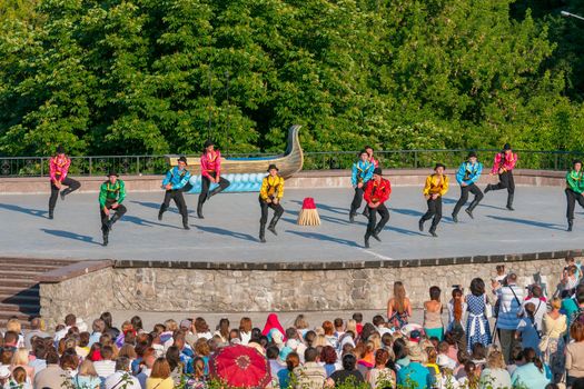 KIEV, UKRAINE - July 22 , 2016: Ukraina School of Dance Ensemble girls and boys dressed in traditional red Ukrainian embroidered costume clothes dancing