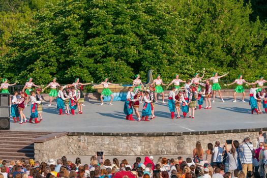 KIEV, UKRAINE - July 22 , 2016: Ukraina School of Dance Ensemble girls and boys dressed in traditional red Ukrainian embroidered costume clothes dancing