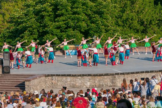 KIEV, UKRAINE - July 22 , 2016: Ukraina School of Dance Ensemble girls and boys dressed in traditional red Ukrainian embroidered costume clothes dancing