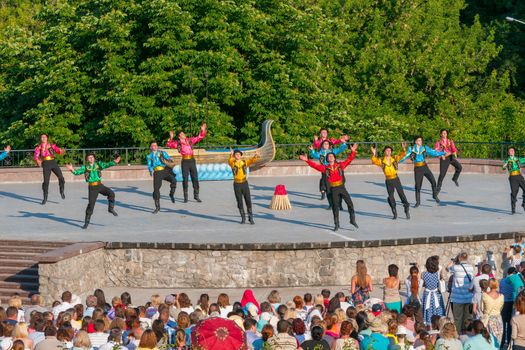 KIEV, UKRAINE - July 22 , 2016: Ukraina School of Dance Ensemble girls and boys dressed in traditional red Ukrainian embroidered costume clothes dancing