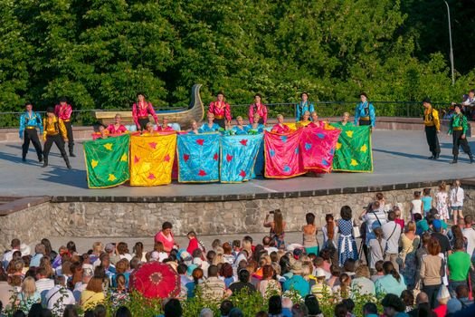 KIEV, UKRAINE - July 22 , 2016: Ukraina School of Dance Ensemble girls and boys dressed in traditional red Ukrainian embroidered costume clothes dancing