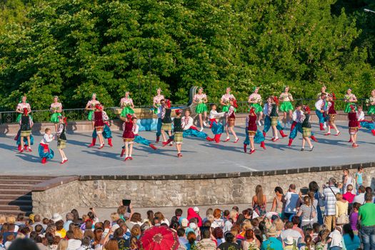 KIEV, UKRAINE - July 22 , 2016: Ukraina School of Dance Ensemble girls and boys dressed in traditional red Ukrainian embroidered costume clothes dancing