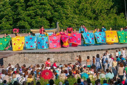 KIEV, UKRAINE - July 22 , 2016: Ukraina School of Dance Ensemble girls and boys dressed in traditional red Ukrainian embroidered costume clothes dancing