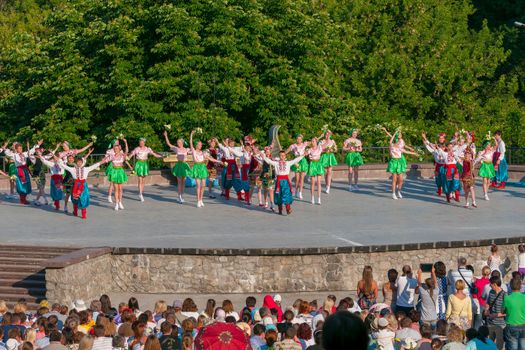 KIEV, UKRAINE - July 22 , 2016: Ukraina School of Dance Ensemble girls and boys dressed in traditional red Ukrainian embroidered costume clothes dancing