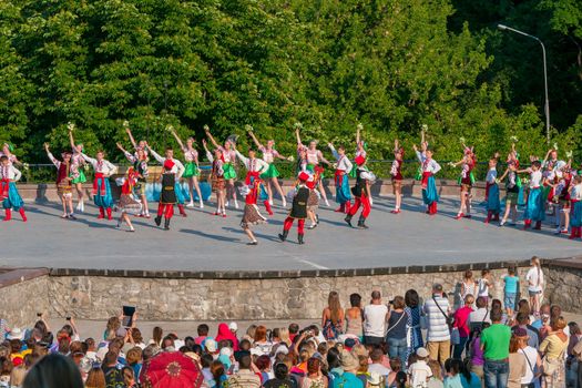 KIEV, UKRAINE - July 22 , 2016: Ukraina School of Dance Ensemble girls and boys dressed in traditional red Ukrainian embroidered costume clothes dancing