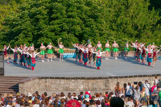 KIEV, UKRAINE - July 22 , 2016: Ukraina School of Dance Ensemble girls and boys dressed in traditional red Ukrainian embroidered costume clothes dancing