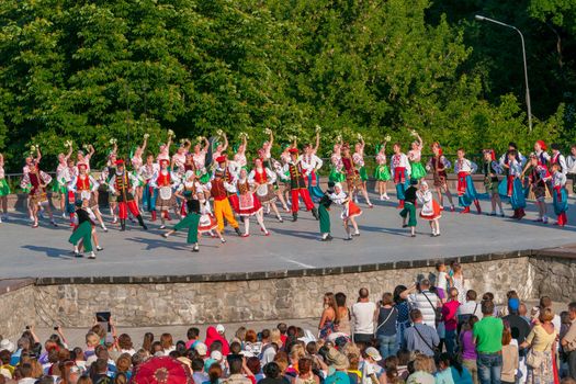 KIEV, UKRAINE - July 22 , 2016: Ukraina School of Dance Ensemble girls and boys dressed in traditional red Ukrainian embroidered costume clothes dancing