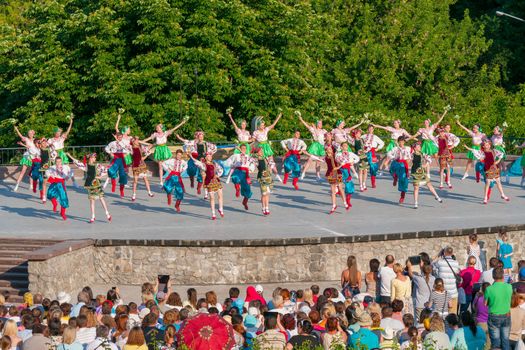 KIEV, UKRAINE - July 22 , 2016: Ukraina School of Dance Ensemble girls and boys dressed in traditional red Ukrainian embroidered costume clothes dancing