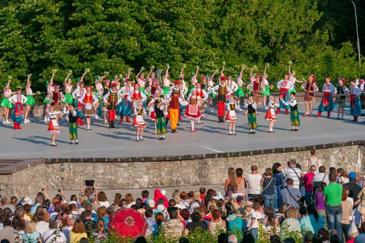 KIEV, UKRAINE - July 22 , 2016: Ukraina School of Dance Ensemble girls and boys dressed in traditional red Ukrainian embroidered costume clothes dancing