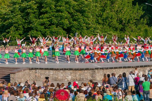 KIEV, UKRAINE - July 22 , 2016: Ukraina School of Dance Ensemble girls and boys dressed in traditional red Ukrainian embroidered costume clothes dancing