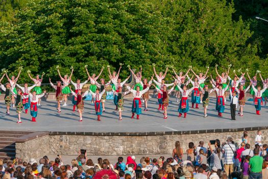 KIEV, UKRAINE - July 22 , 2016: Ukraina School of Dance Ensemble girls and boys dressed in traditional red Ukrainian embroidered costume clothes dancing