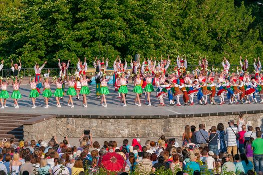 KIEV, UKRAINE - July 22 , 2016: Ukraina School of Dance Ensemble girls and boys dressed in traditional red Ukrainian embroidered costume clothes dancing