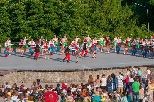 KIEV, UKRAINE - July 22 , 2016: Ukraina School of Dance Ensemble girls and boys dressed in traditional red Ukrainian embroidered costume clothes dancing