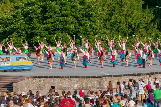 KIEV, UKRAINE - July 22 , 2016: Ukraina School of Dance Ensemble girls and boys dressed in traditional red Ukrainian embroidered costume clothes dancing